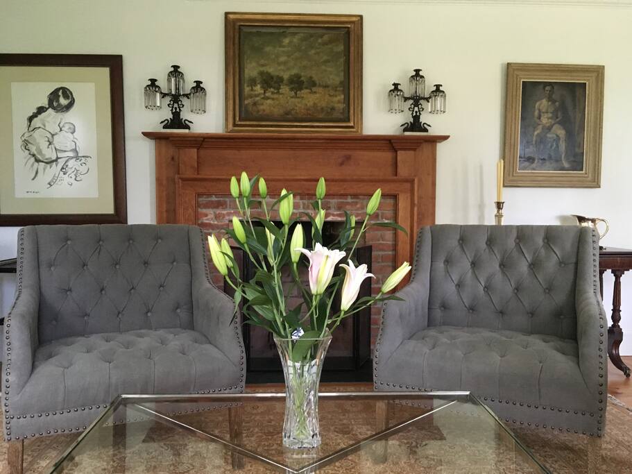 The living room is filled with light and looks out onto the fields and woods.