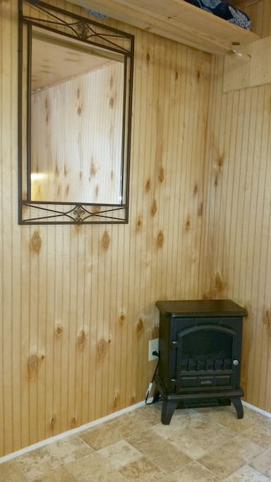 Downstairs bedroom has a full length hanging rod plus a mirror, extra blankets and a heater.