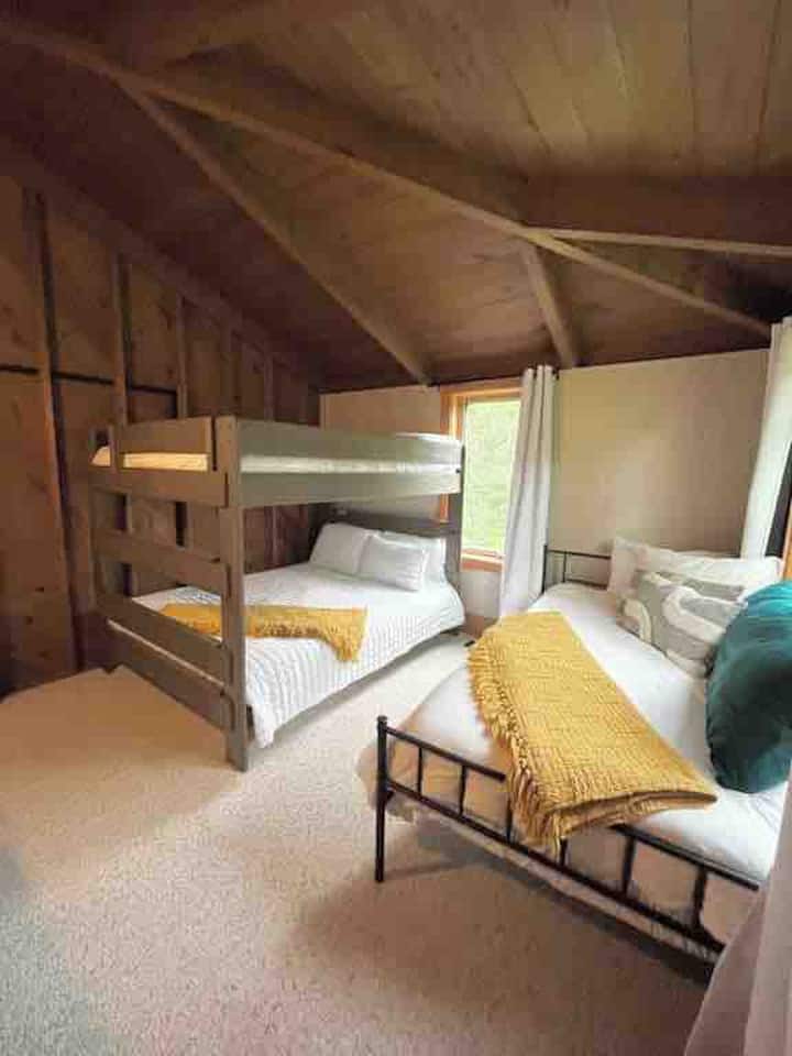Bunk room with queen over queen bunk and XL twin