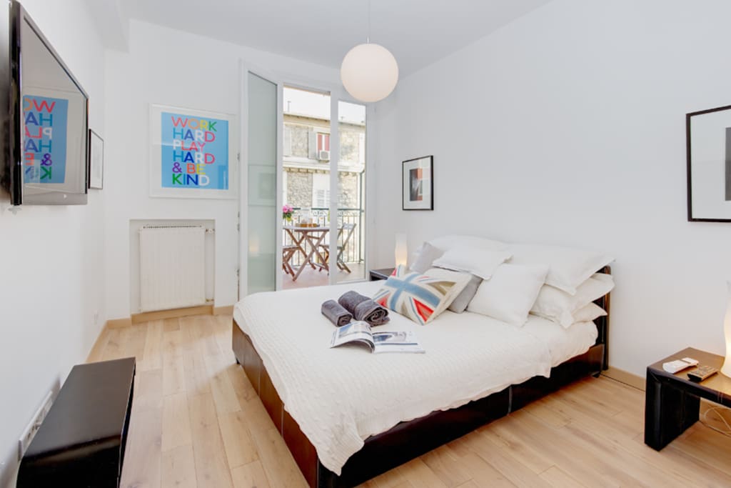 Large bedroom with TV and double bed.