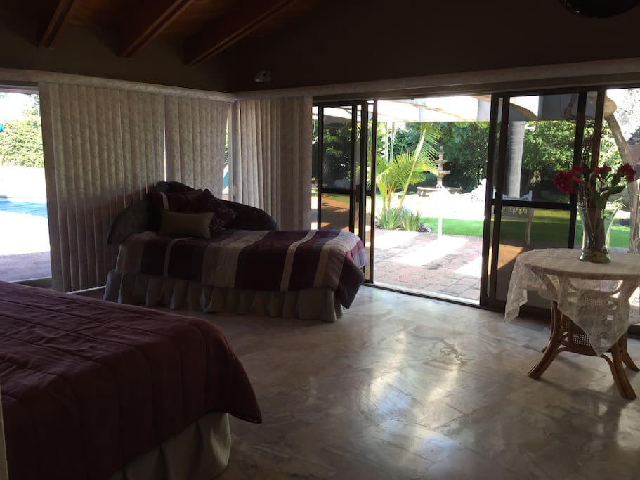 Master Bedroom with 180 degrees view of the garden and pool