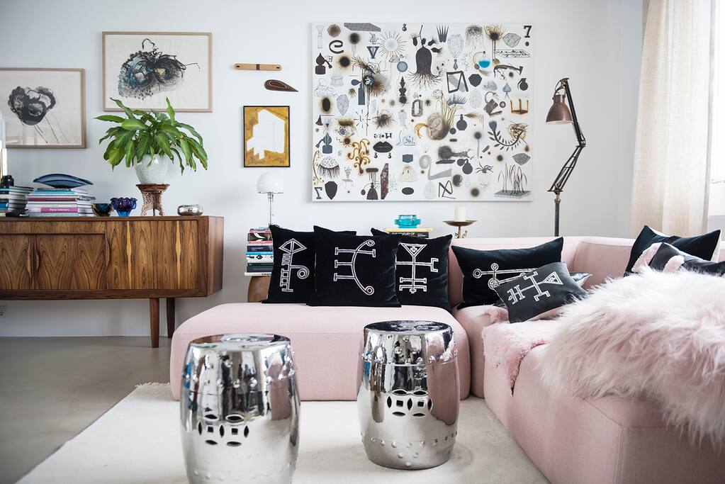 Living room is bright and open. Filled with interesting art pieces.