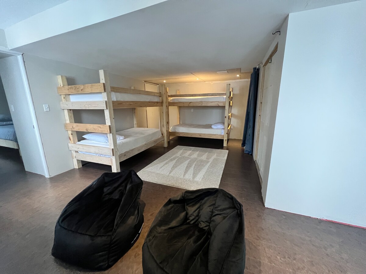 Make bedtime an adventure with the unique bunk bed room, offering 2 single bunks, a TV, a toy closet filled with fun and games, a bookshelf brimming with tales to be told, and a small table perfect for imaginative coloring sessions - a kids' haven