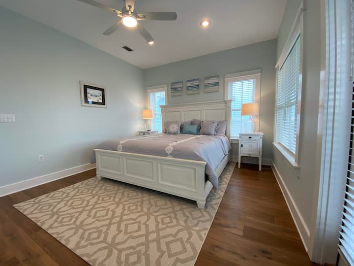 חדר שינה ראשי בקומה השלישית עם מיטת קינג וטלוויזיה חכמה.