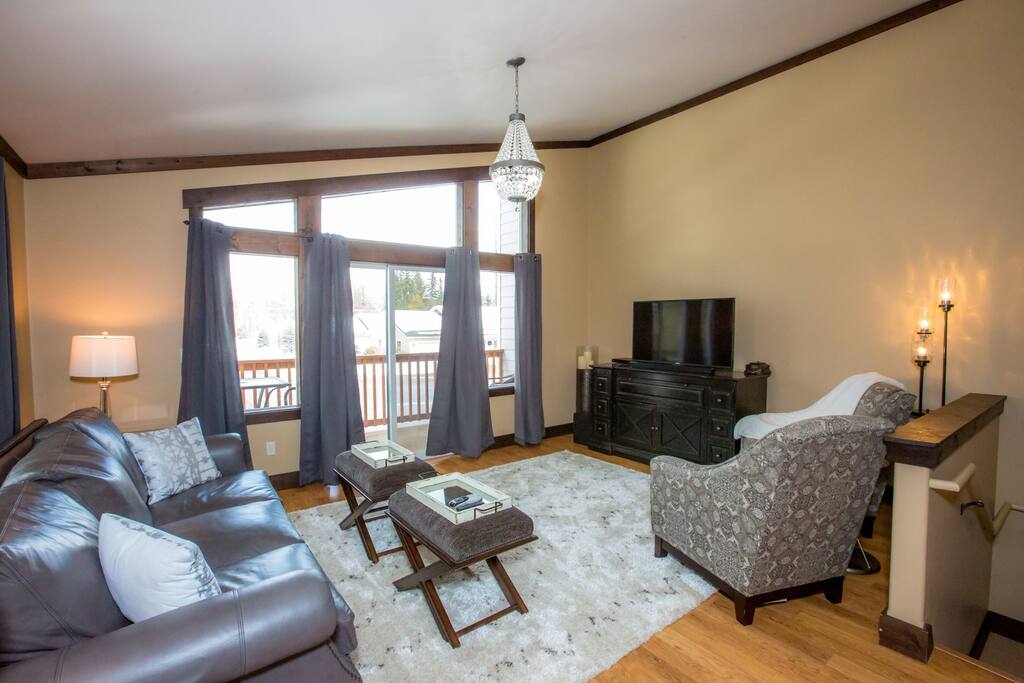 Open living room space with flatscreen TV and comfy seating for all.