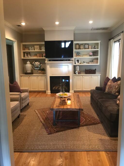 Living room. Large couch and two wingback recliners. Also floor poufs available for extra seating.