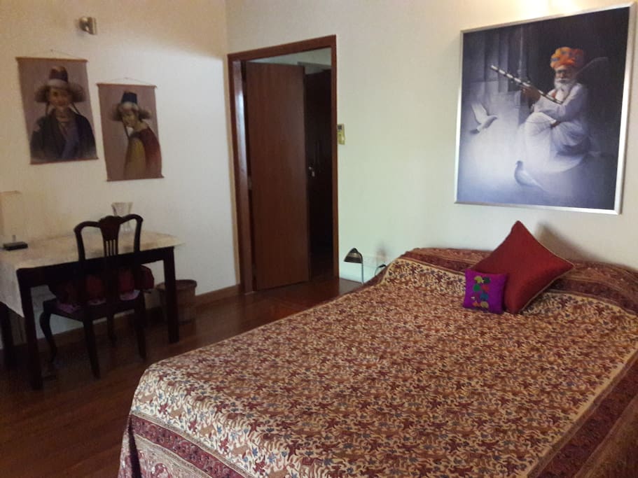 Well appointed ground floor guest room with a wooden floor, and work desk