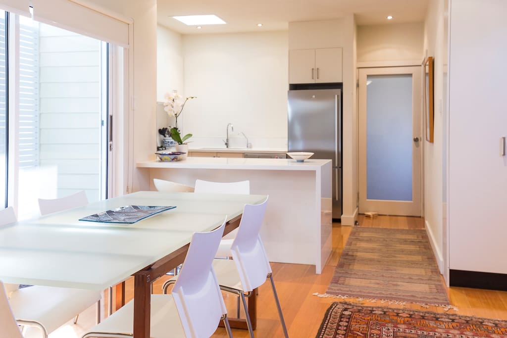 Contemporary furnishings and oriental rugs in the open plan dining/kitchen area