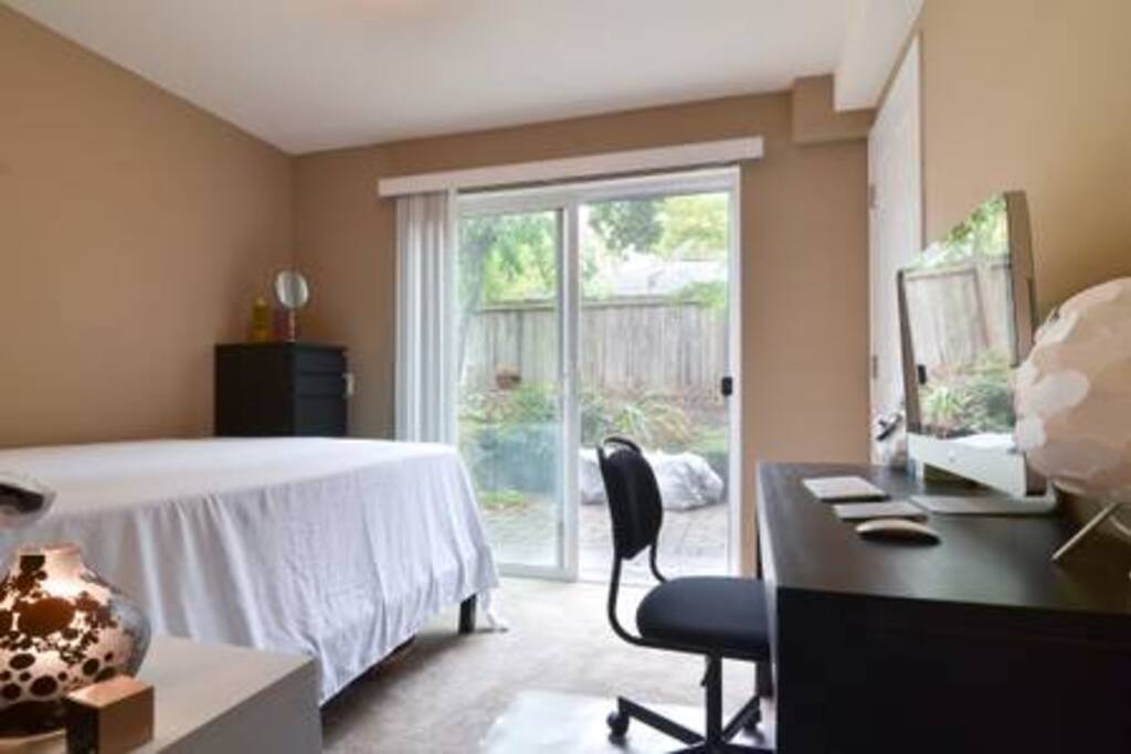 Bedroom walk out to a paito and garden