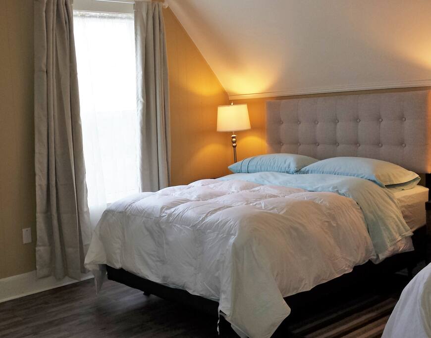 Full Size Bed Besides Window