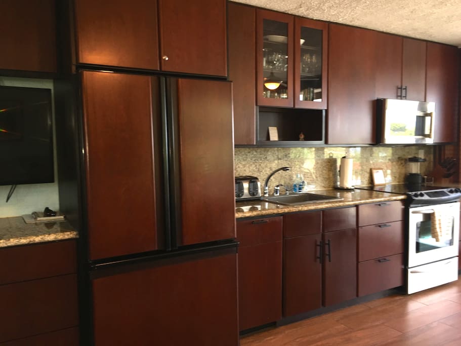 Kitchen with cherry cabinets and stainless steel appliances
