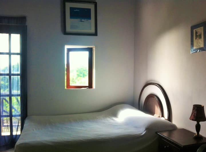 Comfortable bedroom with built in wardrobes and leads to patio