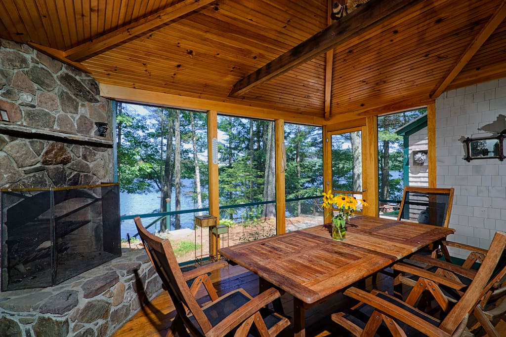 We practically live out here in the summer. Right off the kitchen with a big table, lake views and a large stone fireplace; it's pretty great.