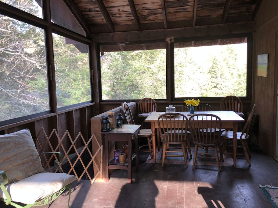 Large screened in porch with dining table