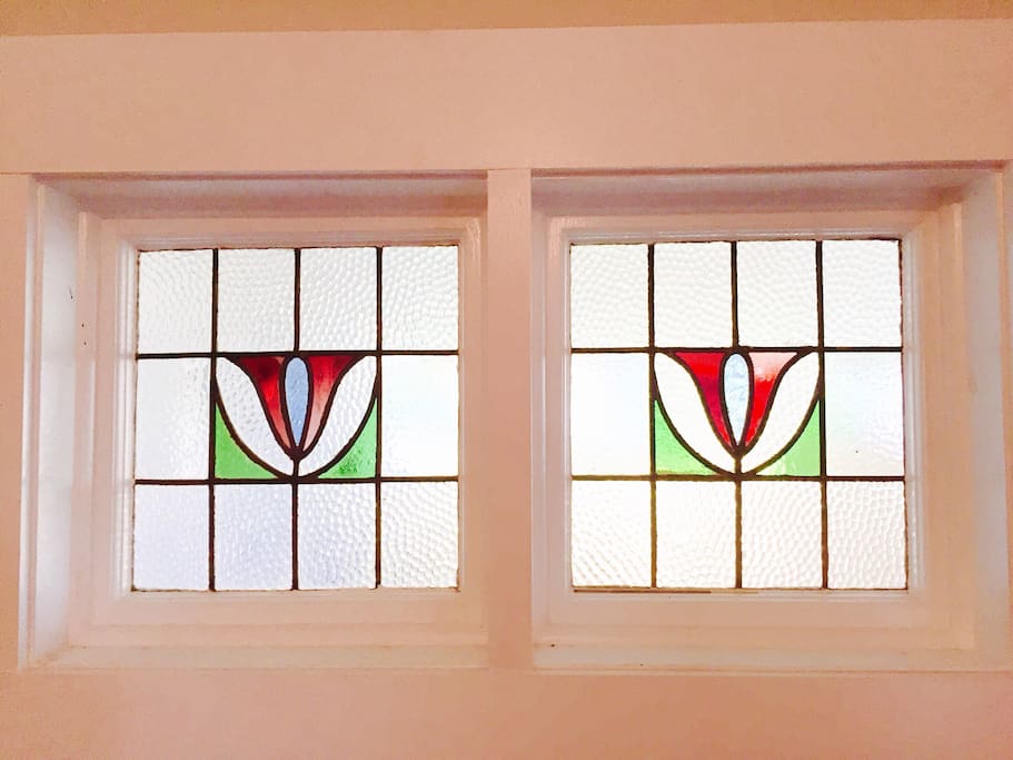 Stained glass windows above king size bed are adding magical lightning to the bedroom ambience!