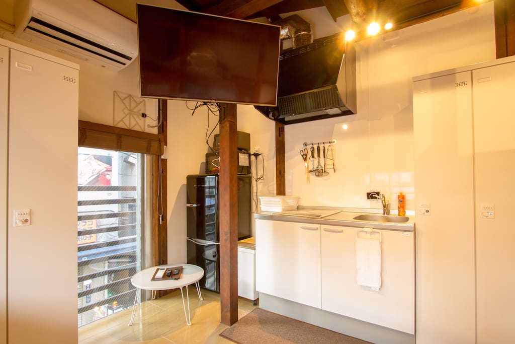 Inside the room there is a big TV and kitchen, fridge and microwave.