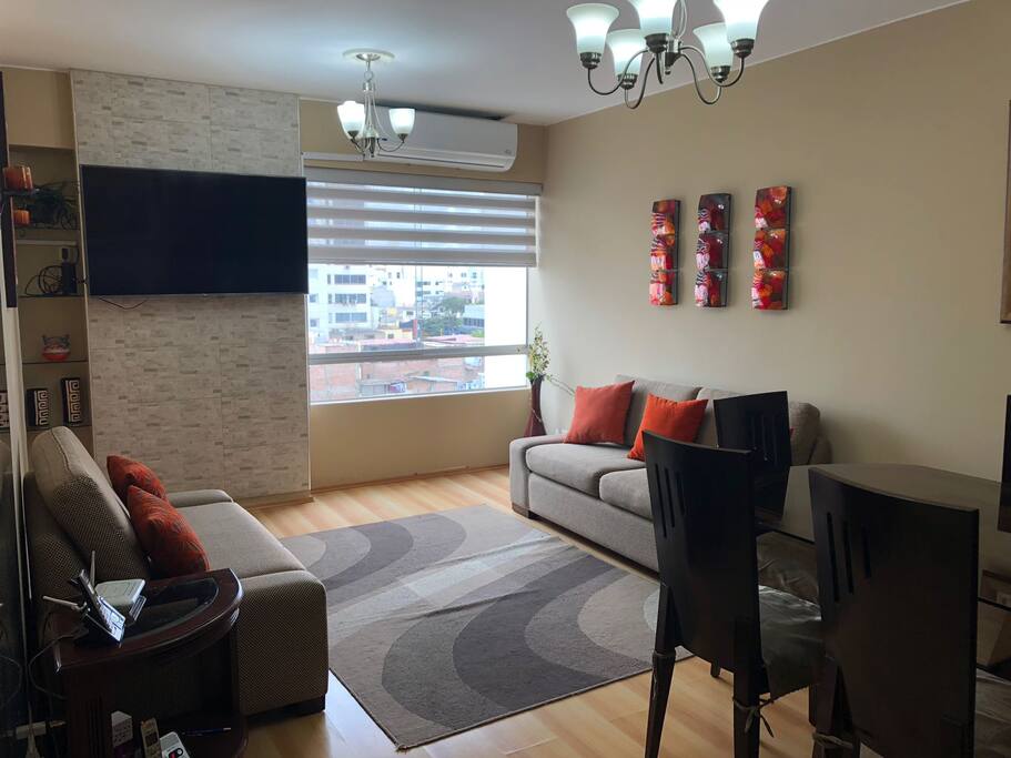 Living room with flat screen TV & A/C unit