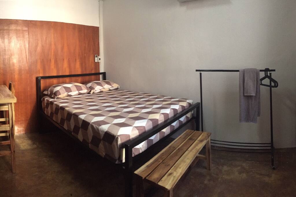 This is bedroom 5 of 5 bedrooms. Each bedroom has 1 air conditioner, 1 queen bed (1 fitted sheet, 1 flat sheet, 2 pillows in cases), 1 table, 1 stool, 1 bench, 1 clothes rack, 4 hangers. 4th floor.
