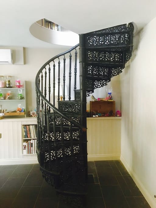Spiral staircase up to the bedroom and bathroom