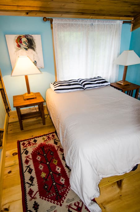 A very comfy queen-size bed is in the bedroom space.