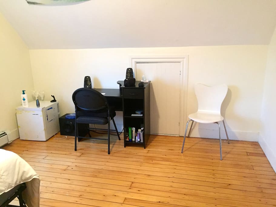 Spacious room with mini-fridge and small desk