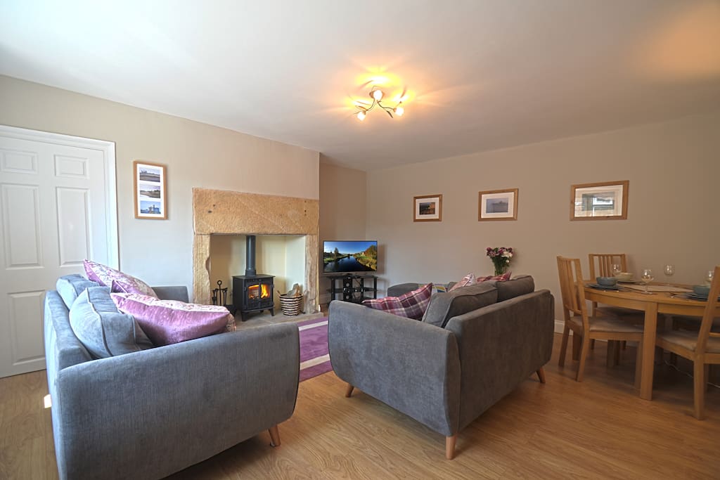 The spacious Living Room offers a stove, comfy sofas and a Dining Table for four people.