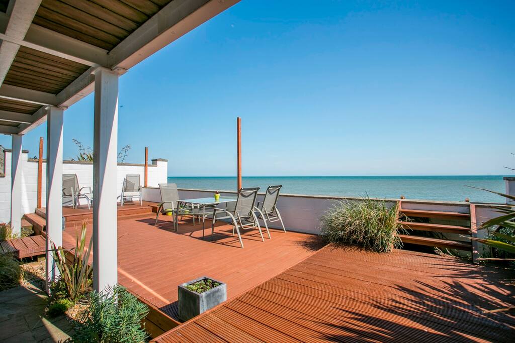 Large decked area overlooking the private beach