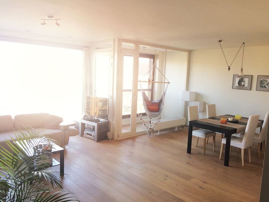 Light and spacious living room with large windows and an indoor balcony