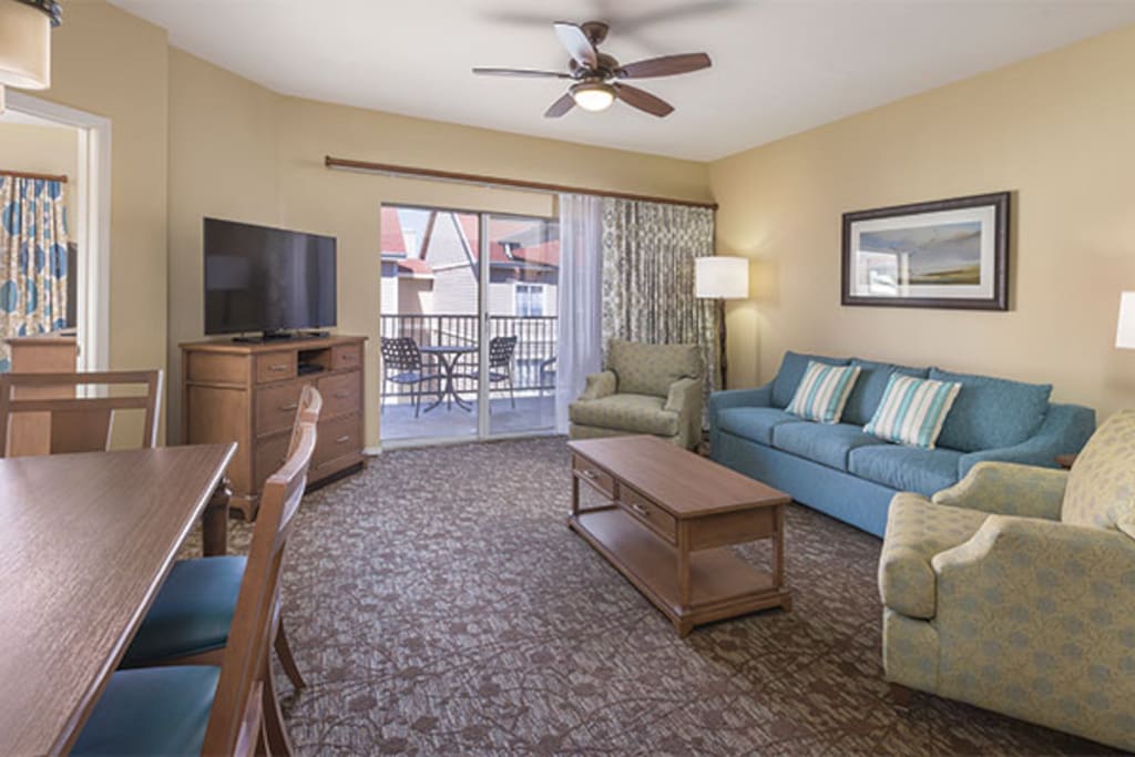 Decor is the same, but the Suite Living Area is smaller, has a round table for 4, and lacks balcony. See Floor Plan.