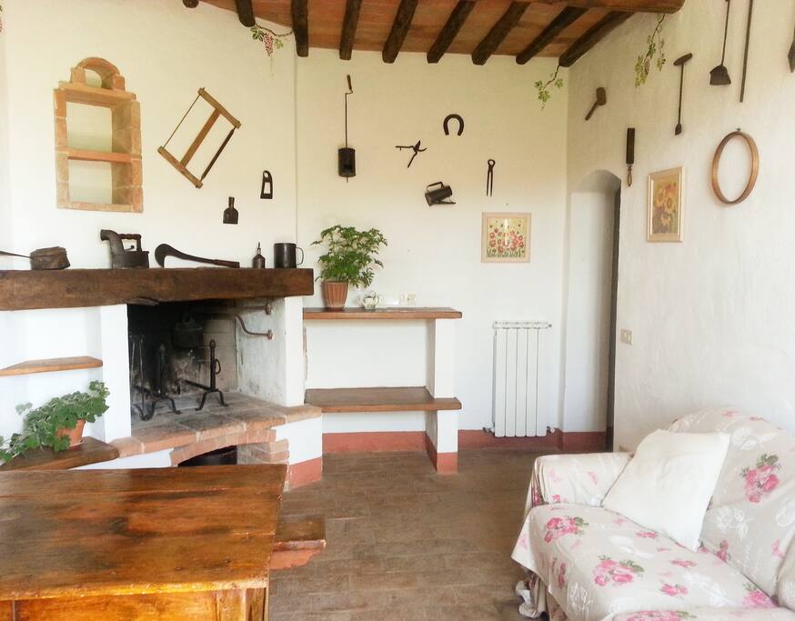 The living/dining area of the apartment with open fire place.