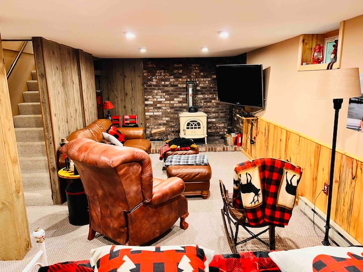 Downstairs family room with wood burning fireplace, TV, and games.