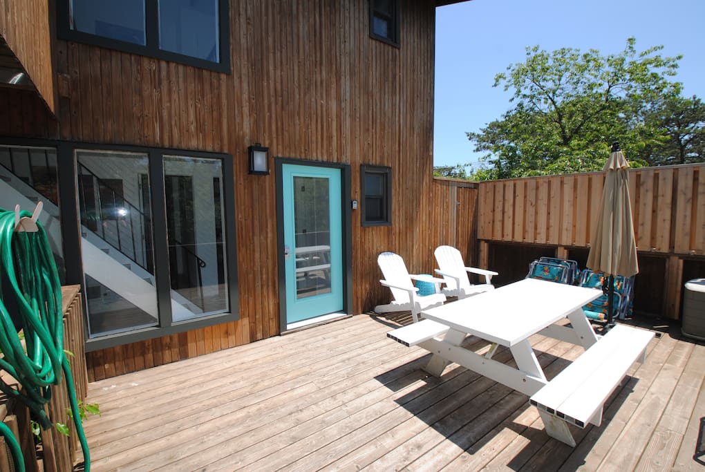 This is the first floor entry deck featuring a picnic table with seating for 6 and 2 Adirondack chairs