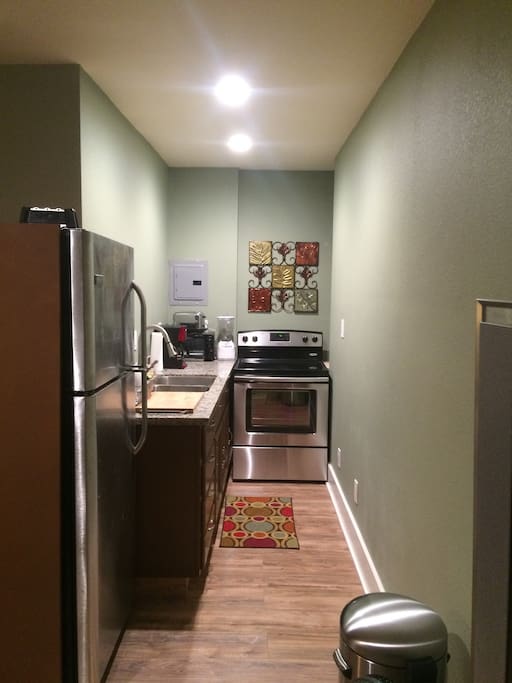 Full kitchen, including a range, full refrigerator, toaster, microwave and more!