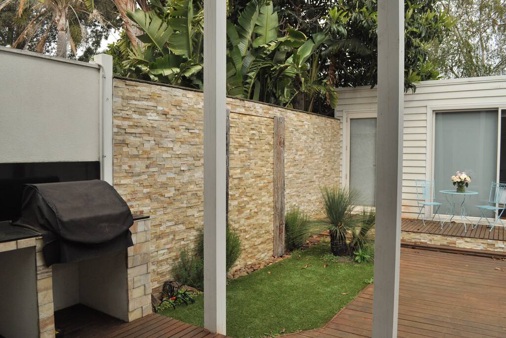 BBQ and spacious garden with water feature