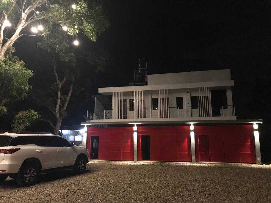 This is the building. It has own garage for your car or just use it extra private space. Small lights are attached to mango tree to lighten up place.