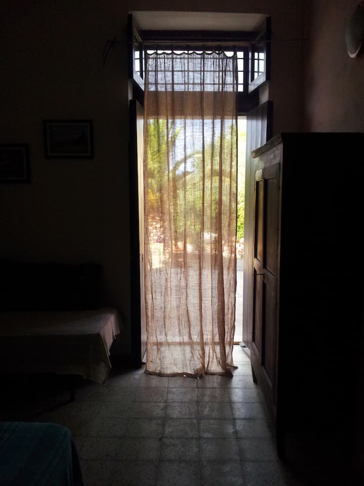studio with a view of the baglio and garden, the curtains safeguard privacy and shade when the heat is felt, outside we set up an additional heavier