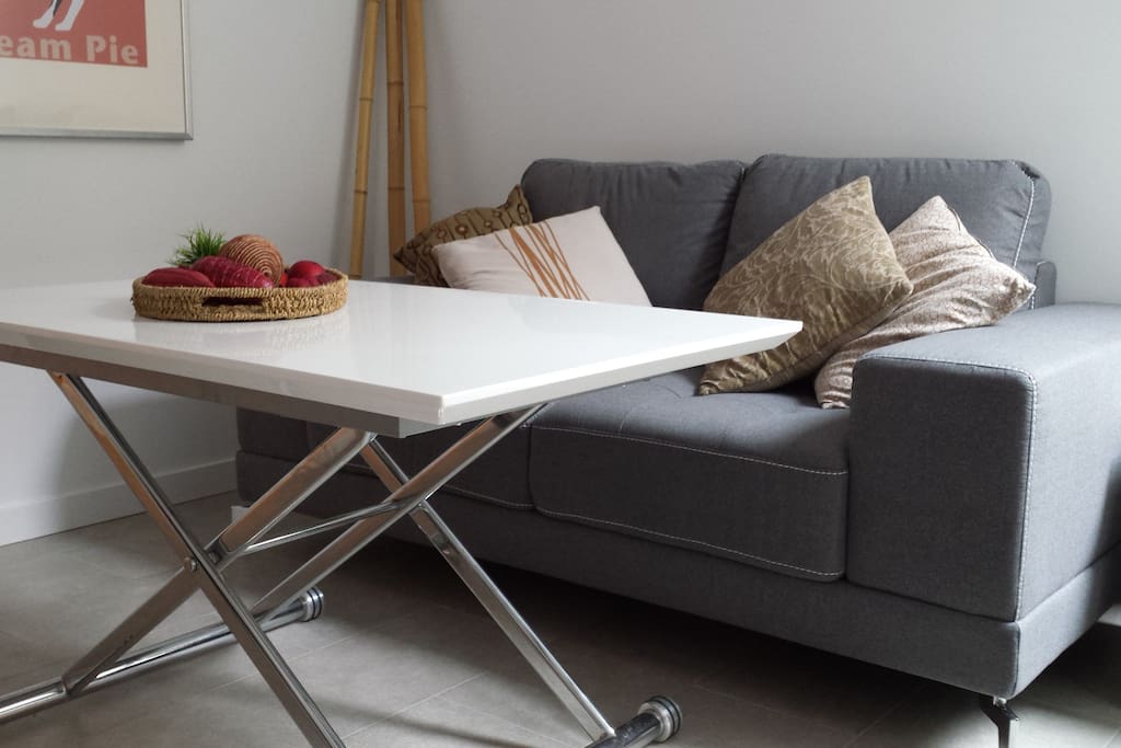 Coffee table adjusts to dinner table/desk top height.