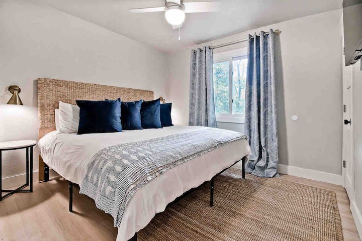 Elegantly decorated 2nd bedroom has a king sized bed and walk-in closet