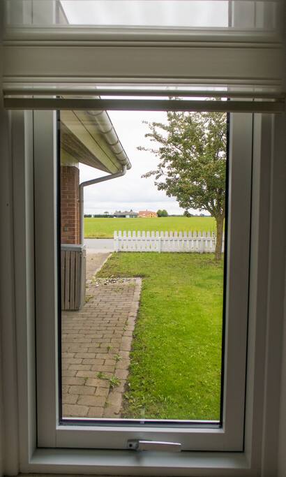 View from the bedroom to the open field in front of the house