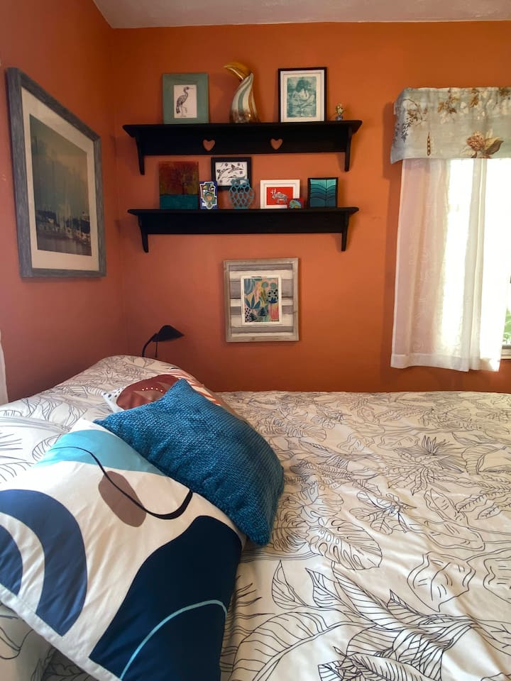 The Orange Room with king bed and fun lamp.