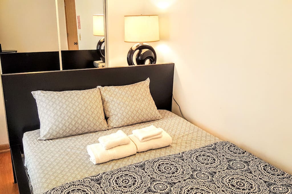 This is exactly how you will find your bedroom upon checking in. Sheets, blanket and towels are provided. Mattress is GREEN TEA MEMORY FOAM. There is a full sized mirror in your room!