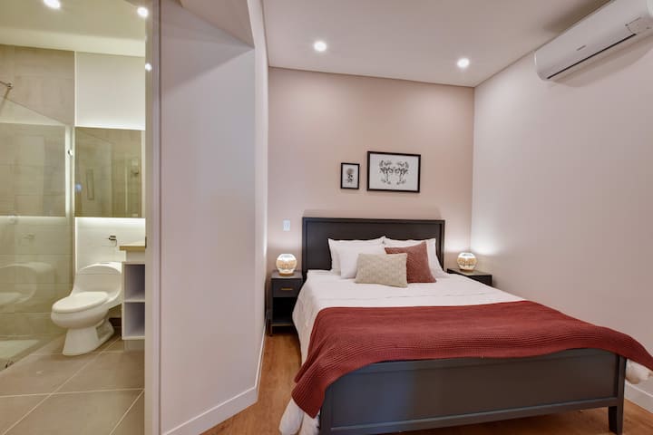 The bedroom is located in the back of the apartment with easy access to bathroom.