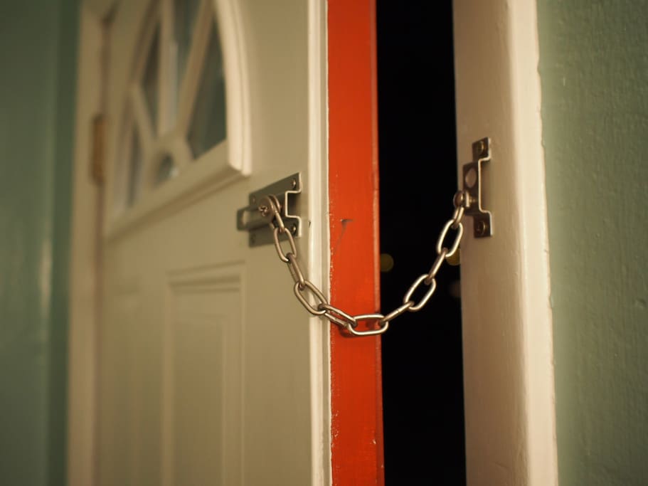 Inside of front door has a chain lock in addition to the deadbolt.