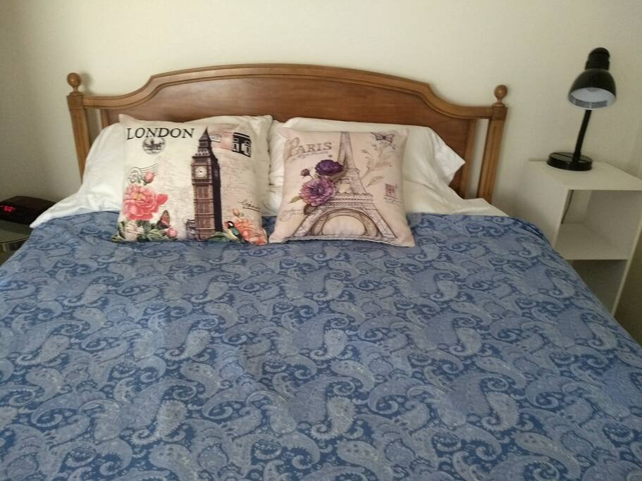 The bed has a nightstand and clock on one side and reading light on the other. A Queen-size bed, pillow top mattress and all-cotton bedding help you get a good night's sleep.