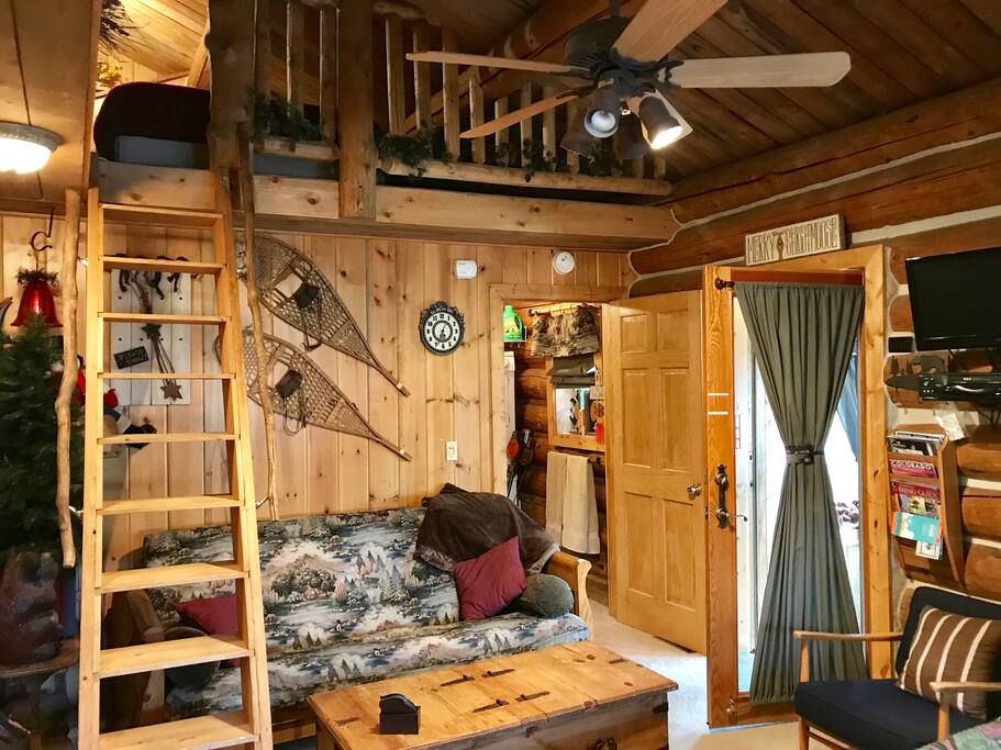 View of built in staircase/Ladder to loft w/queen bed & couch near king bed.
