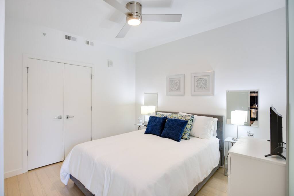 Bedroom with queen size bed and TV