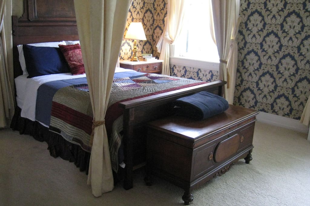 The Megan Rice room features a four-poster bed, dresser, cedar chest, ample closet space, and a bright private bathroom with shower.