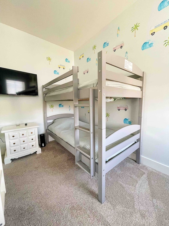 The double bunk room. There are two twin bunkbeds, a smart TV, and a walk-in closet.