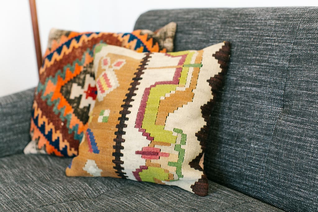 There are pillows and blankets for getting comfy on the couch.
