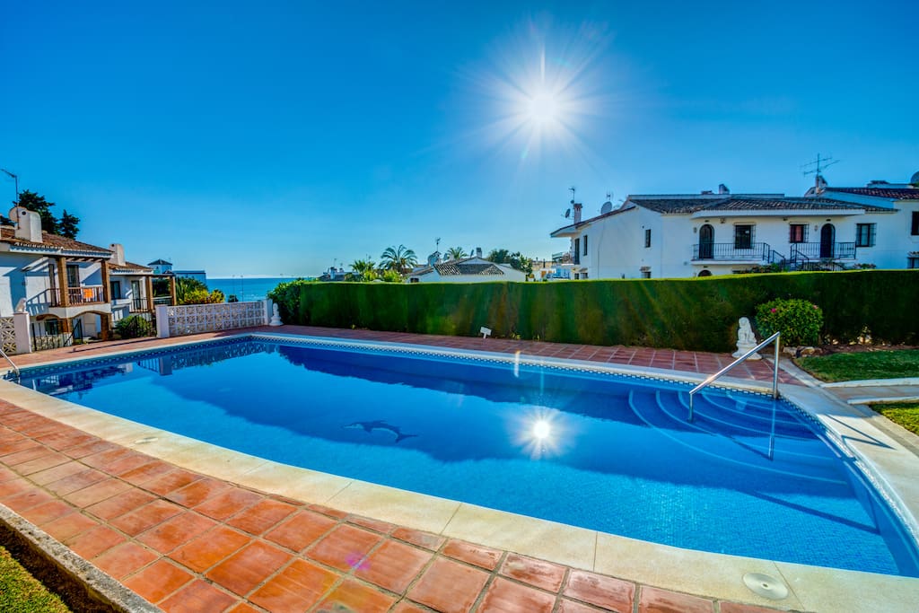 Lovely pool with sea views and with finely framed with garden and bushes.
